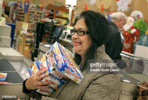 Helen Lumpp heads to the checkout with an armload of Hostess snacks at a Jewel-Osco grocery store on December 11, 2012 in Chicago, Illinois. The...