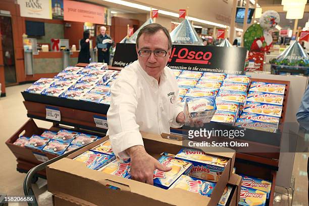 John Kolton stocks a display of Hostess snacks at a Jewel-Osco grocery store on December 11, 2012 in Chicago, Illinois. The Jewel-Osco grocery store...