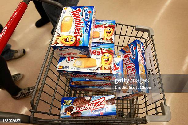 Customer heads to the checkout with a shopping cart loaded with Hostess snacks at a Jewel-Osco grocery store on December 11, 2012 in Chicago,...