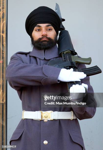 Sikh Guardsman Jatenderpal Singh Bhullar, a soldier in the Scots Guards, stands by his sentry box whilst on guard duty in the forecourt of Buckingham...