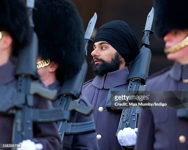 Sikh Guardsman Jatenderpal Singh Bhullar , a soldier in the Scots Guards, forms up with his fellow soldiers on the parade ground of Wellington...