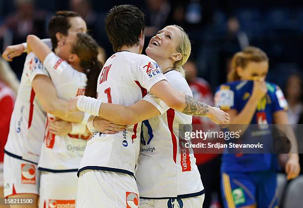 Heidi Loke and Anja Edin of Norway celebrate victory over Sweden after the Women's European Handball Championship 2012 Group I main round match...
