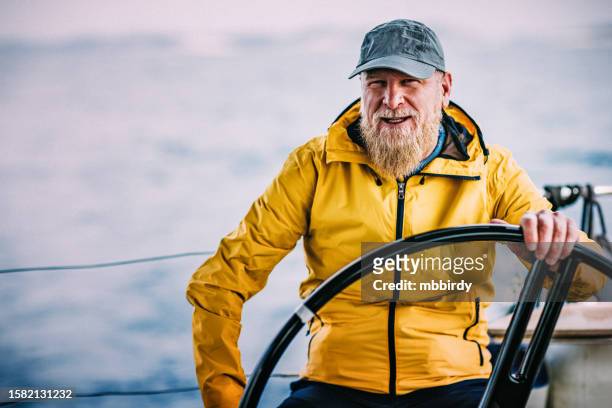 skipper sailing on sailboat - boat captain stock pictures, royalty-free photos & images