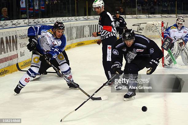 Sebastian Osterloh of Straubing is challenged by Jason Jaspers of Ice Tigers during the DEL match between Thomas Sabo Ice Tigers and Straubing Tigers...