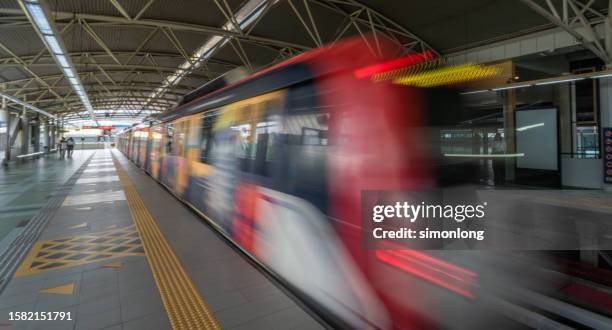 speeding train traveling - estado de selangor fotografías e imágenes de stock