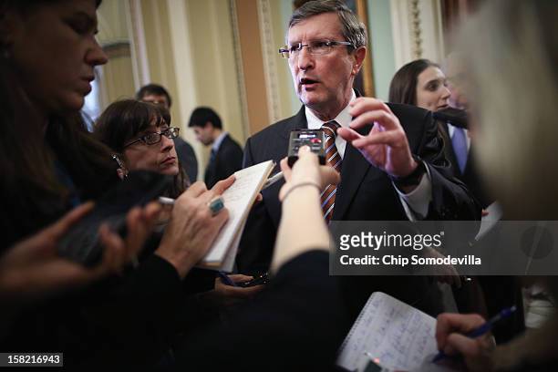 Senate Budget Committee Chairman Kent Conrad talks to reporters after the Senate Democrats' weekly policy luncheon at the U.S. Capitol December 11,...