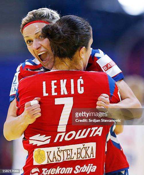 Ivana Milosevic and Andrea Lekic of Serbia celebrate a score during the Women's European Handball Championship 2012 Group I main round match between...