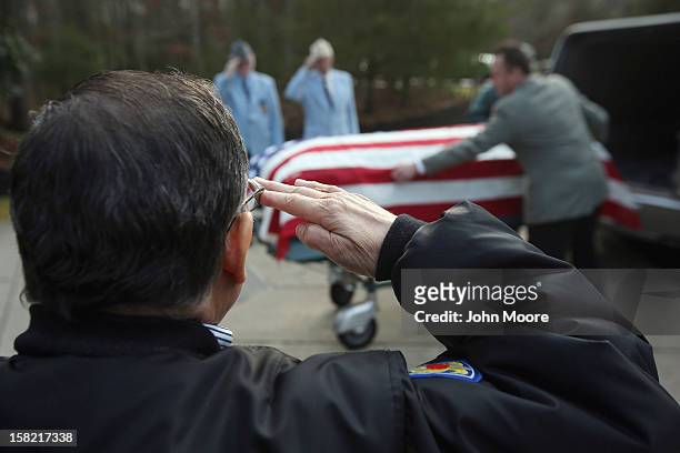 The body of Hurricane Sandy victim David Maxwell arrives for burial at the Calverton National Cemetery on December 11, 2012 near the Wading River...