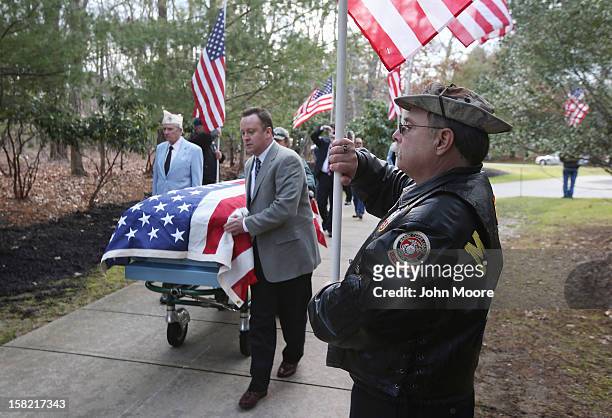 The body of Hurricane Sandy victim David Maxwell arrives for burial at the Calverton National Cemetery on December 11, 2012 near the Wading River...