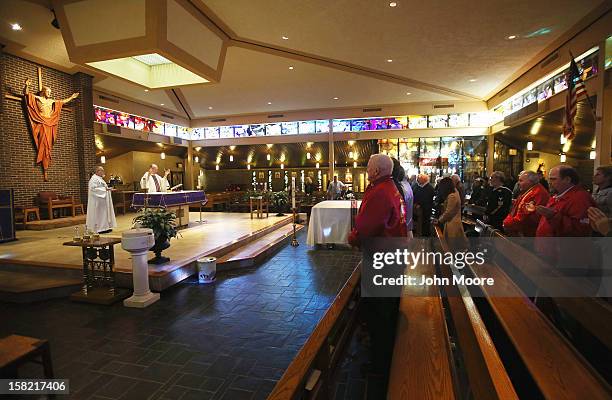 Mourners attend a Catholic mass for Hurricane Sandy victim David Maxwell at the St. Charles Catholic Church on December 11, 2012 in the Staten Island...