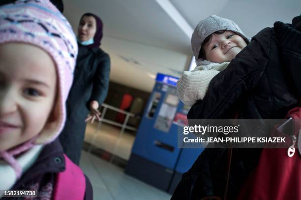 The Algerian child Manil, eight months old, arrives from Algeria along with his mother and his sister to Lyon's airport to be transfered in a French...