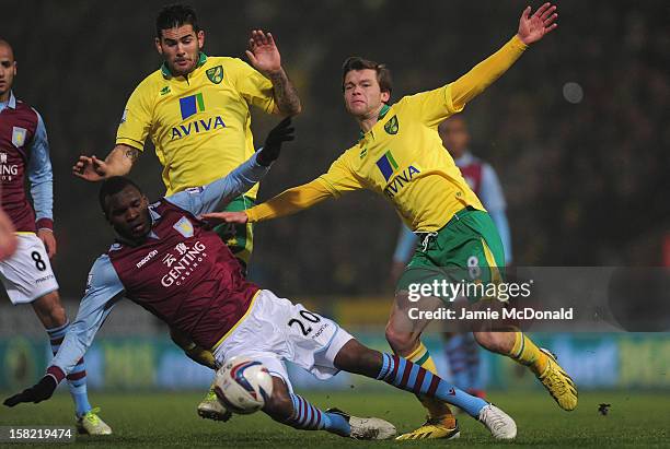 Christian Benteke of Aston Villa battles with Jonny Howson of Norwich City during the Capital One Cup Quarter-Final match between Norwich City and...