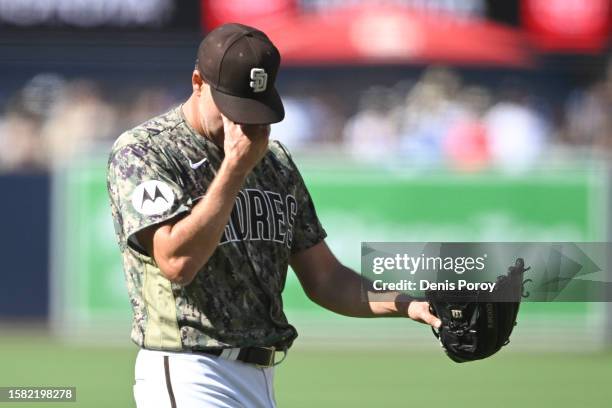 Rich Hill of the San Diego Padres walks of the field after pitching in the first inning against the against the Los Angeles Dodgers on August 6, 2023...