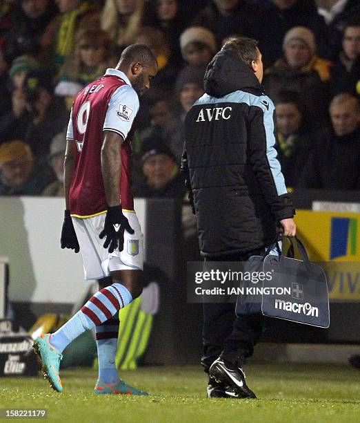 Aston Villa's English striker Darrent Bent holds his leg after an injury during the English League Cup quarter final football match against Norwich...