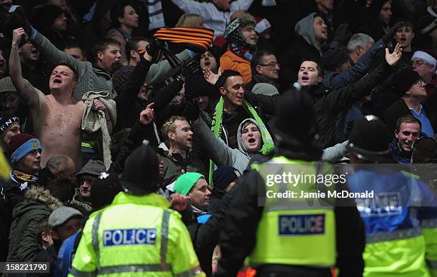 Police keep an eye on the Aston Villa fans during the Capital One Cup Quarter-Final match between Norwich City and Aston Villa at Carrow Road on...