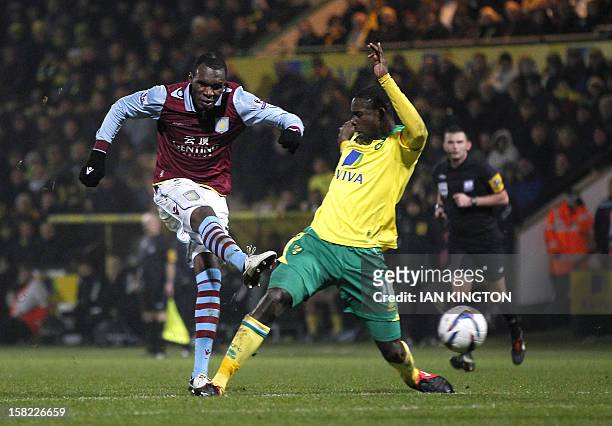 Norwich City's English defender Leon Barnett tries to stop Aston Villa's Congolese-born Belgium striker Christian Benteke from scoring his team's...