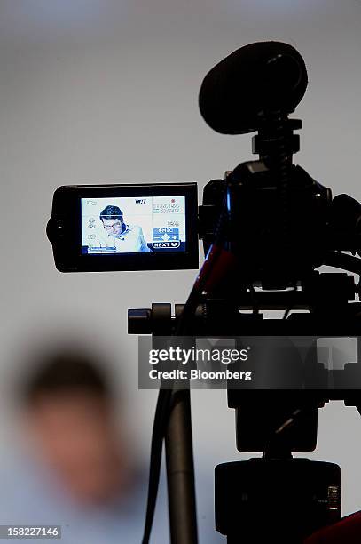 Andrew Mason, chief executive officer at Groupon Inc., is seen through the viewfinder of a camera during a keynote address at the Mobile Loco...