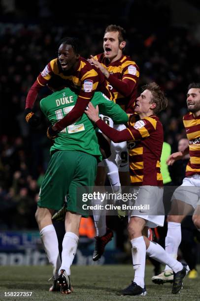 Goalkeeper Matt Duke of Bradford is congratulated by teammates after saving penalty during the shootout to win the Capital One Cup quarter final...