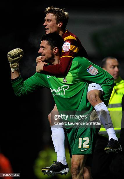 Goalkeeper Matt Duke of Bradford is congratulated by teammate Stephen Darby after saving penalty during the shootout to win the Capital One Cup...