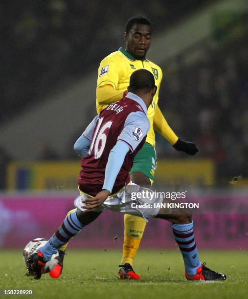 Norwich City's Cameroonian defender Sebastien Bassong vies with Aston Villa's English midfielder Fabian Delph during their English League Cup quarter...