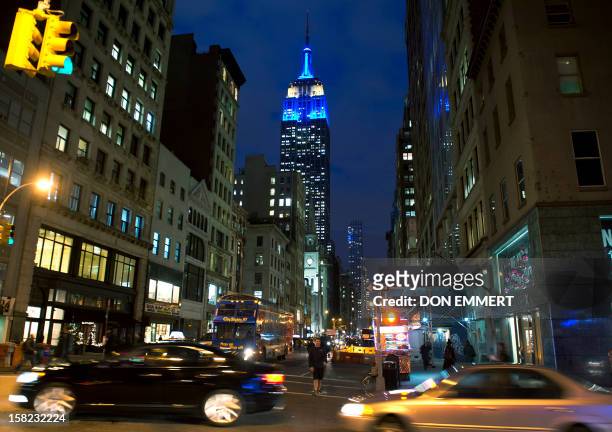 New York City's iconic landmark, the Empire State Building, is lit in the European Union's flag colors, blue and yellow, to mark the award of the...