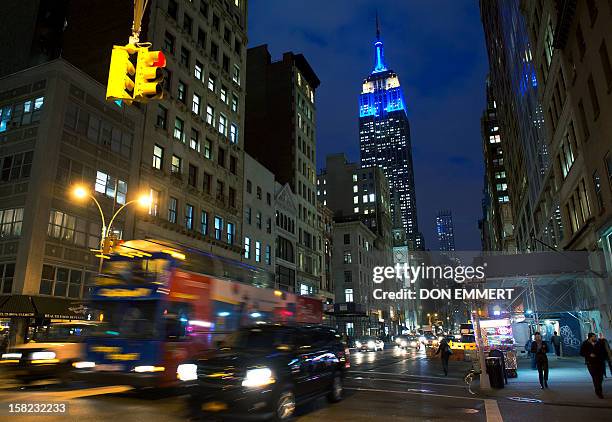 New York City's iconic landmark, the Empire State Building, is lit in the European Union's flag colors, blue and yellow, to mark the award of the...