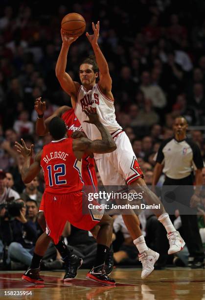 Joakim Noah of the Chicago Bulls passes over Eric Bledsoe of the Los Angeles Clippers at the United Center on December 11, 2012 in Chicago, Illinois....