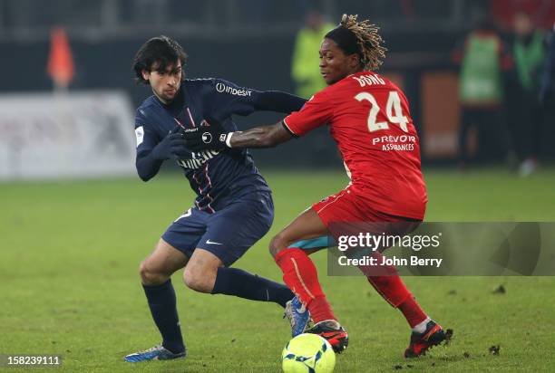 Javier Pastore of PSG fights for the ball with Gaetan Bong of VAFC during the French Ligue 1 match between Valenciennes FC and Paris Saint-Germain FC...