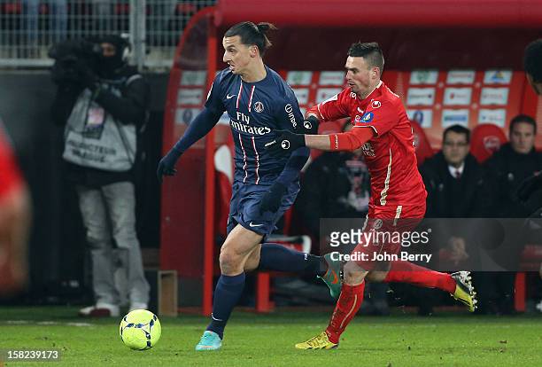 Zlatan Ibrahimovic of PSG is followed by Anthony Le Tallec of VAFC during the French Ligue 1 match between Valenciennes FC and Paris Saint-Germain FC...