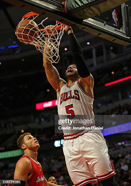 Carlos Boozer of the Chicago Bulls dunks over Blake Griffin of the Los Angeles Clippers on his way to a game-high 24 points at the United Center on...