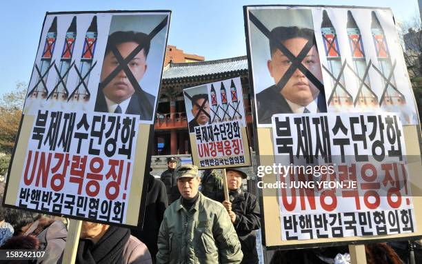 South Korean conservative activists hold anti-North Korea placards reading "Strengthen UN sanctions against North Korea," during a protest denouncing...