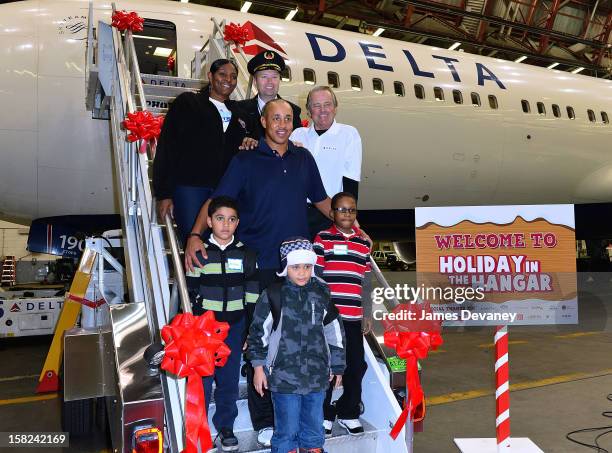 Kym Hampton, John Starks and Rod Gilbert pose with children and a Delta pilot at the 3rd Annual Garden of Dreams Foundation & Delta Air Lines'...