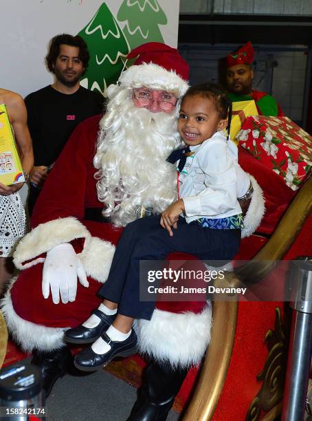 Guests visit Santa at the 3rd Annual Garden of Dreams Foundation & Delta Air Lines' 'Holiday in the Hangar' event at John F. Kennedy International...