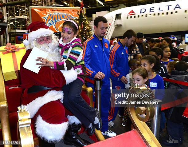 Guests visit Santa at the 3rd Annual Garden of Dreams Foundation & Delta Air Lines' 'Holiday in the Hangar' event at John F. Kennedy International...