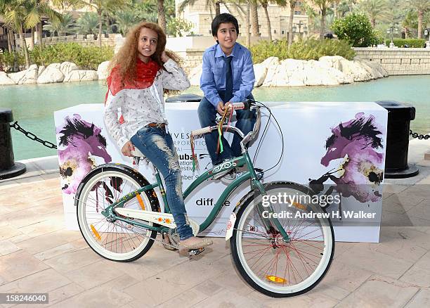 Actors Waad Mohammed and Abdulrahman al Guhani attend the "Wadjda" photocall during day four of the 9th Annual Dubai International Film Festival held...