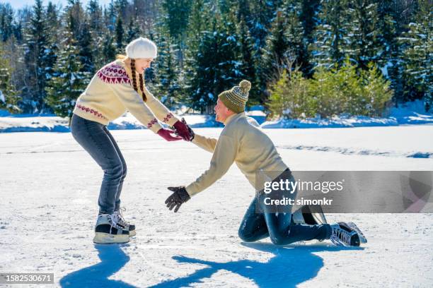 paar schlittschuhlaufen auf zugefrorenem see - skate fail stock-fotos und bilder