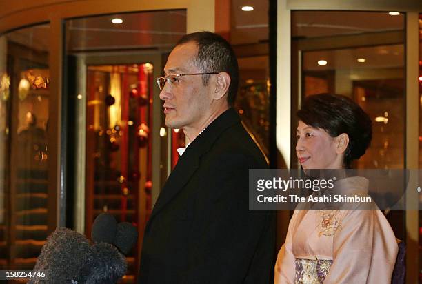 Nobel Prize in Medicine laureate Shinya Yamanaka speaks to the media reporters while his wife Chika listens after attending the Nobel Banquet at Town...