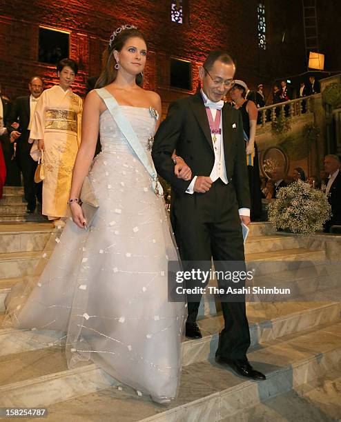 Princess Madeleine of Sweden is escorted by Nobel Prize in Medicine laureate Shinya Yamanaka to the Nobel Banquet at Town Hall on December 10, 2012...