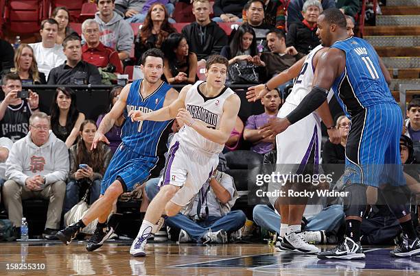 Jimmer Fredette of the Sacramento Kings comes off a screen while defended by J.J. Redick of the Orlando Magic on December 7, 2012 at Sleep Train...