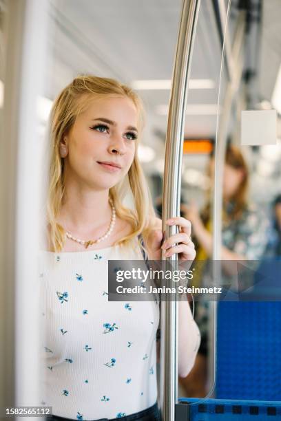 portrait shoot of a young blond woman in a train - zug stock pictures, royalty-free photos & images