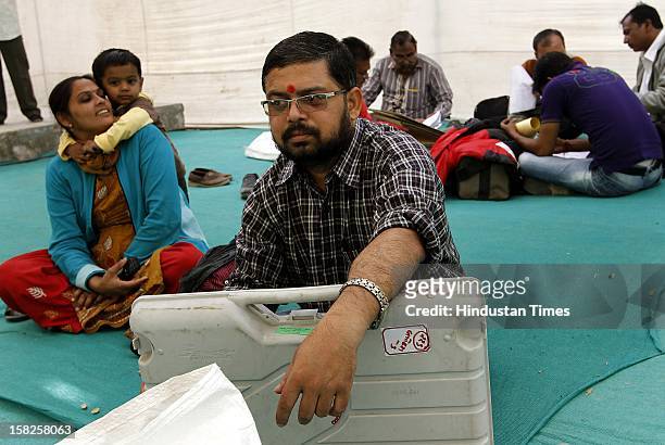 Election duty staffs waiting before leaving for their respective booths for the first phase of Gujarat assembly election on December 12, 2012 in...