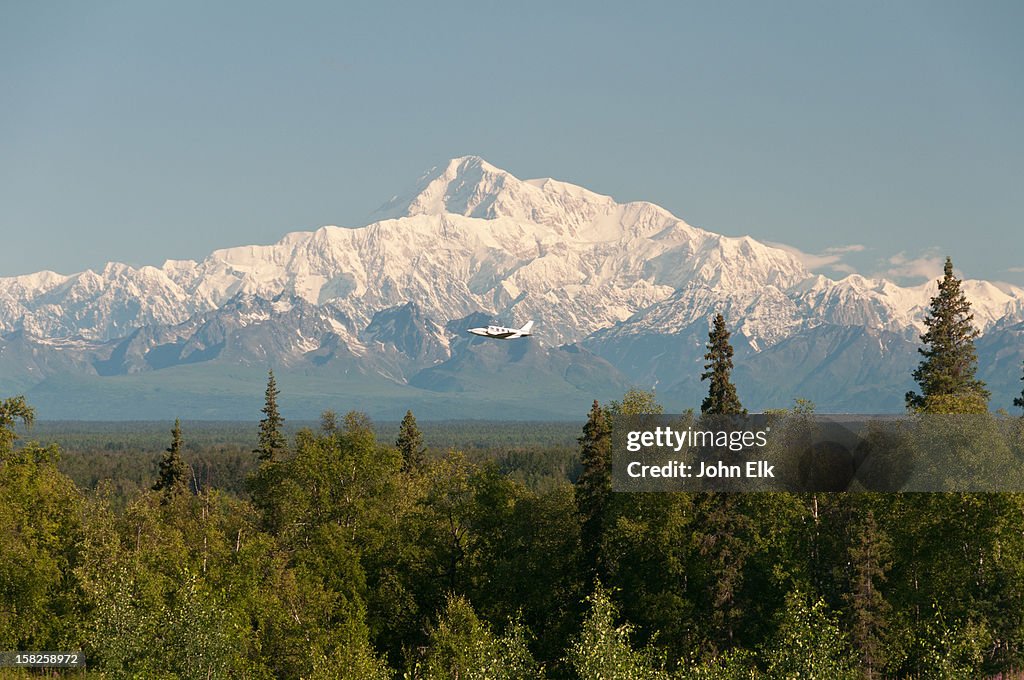 Denali with plane taking off