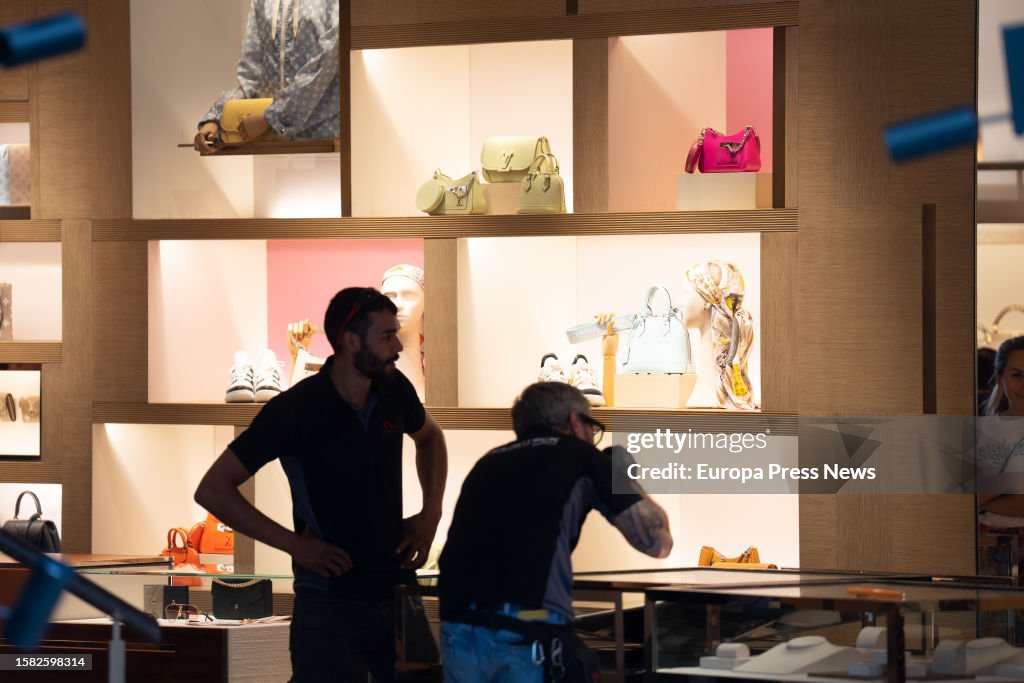 Workers place the damage in the Louis Vuitton store in Barcelona's