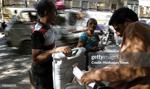 Election duty staffs with Electronic Voting Machine leaving for their respective booths for the first phase of Gujarat assembly election on December...