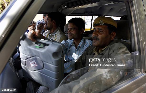 Election duty staffs with Electronic Voting Machine leaving for their respective booths for the first phase of Gujarat assembly election on December...