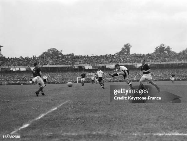 Fritz Walter of West Germany shoots towards goal as Gyula Lorant of Hungary makes a challenge during the FIFA World Cup Final 1954 between West...