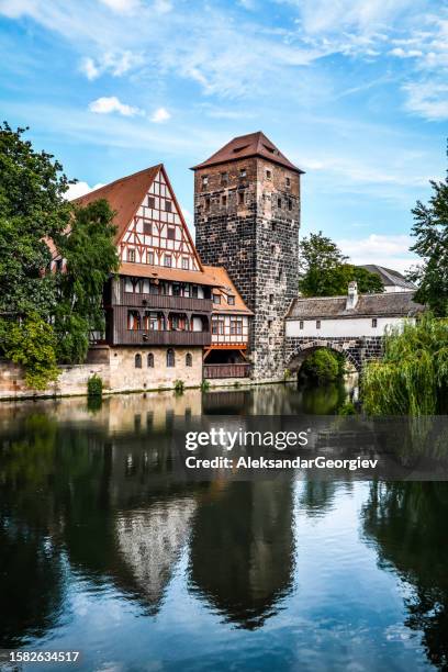 tower of old town and hangman's bridge over pegnitz river in nuremberg, germany - inn stock pictures, royalty-free photos & images