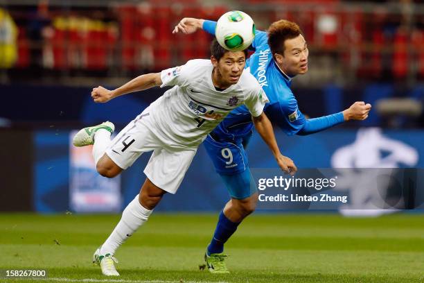 Hiroki Mizumoto of Sanfrecce Hiroshima for an aerial ball with Kim Shinwook of Ulsan Hyundai during the FIFA Club World Cup 5th Place Match match...