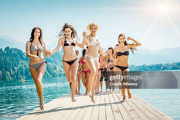 cheering girls at the lake summer vacation - pretty girls in swimsuits bildbanksfoton och bilder