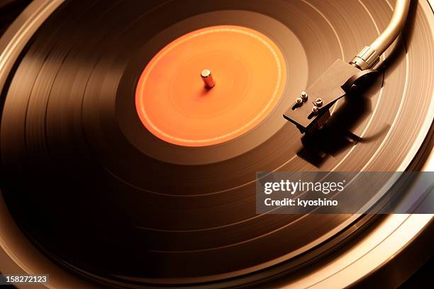 motion of the turntable of warm toned image - groove stock pictures, royalty-free photos & images